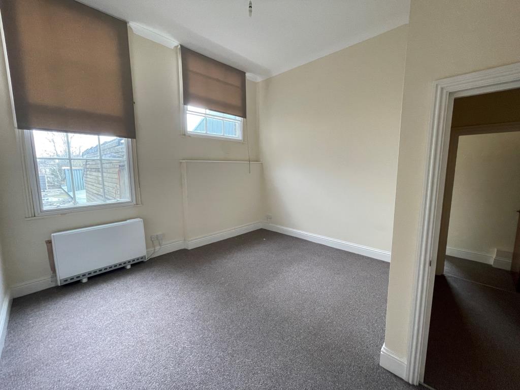 Lot: 24 - VACANT TWO-BEDROOM FLAT - Bedroom with two windows and electric heating
